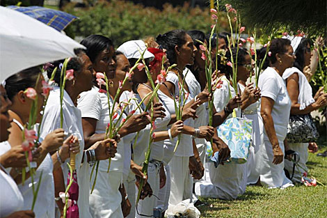 Las Damas de Blanco se arrodillan frente a la Iglesia de Santa Rita. | Reuters